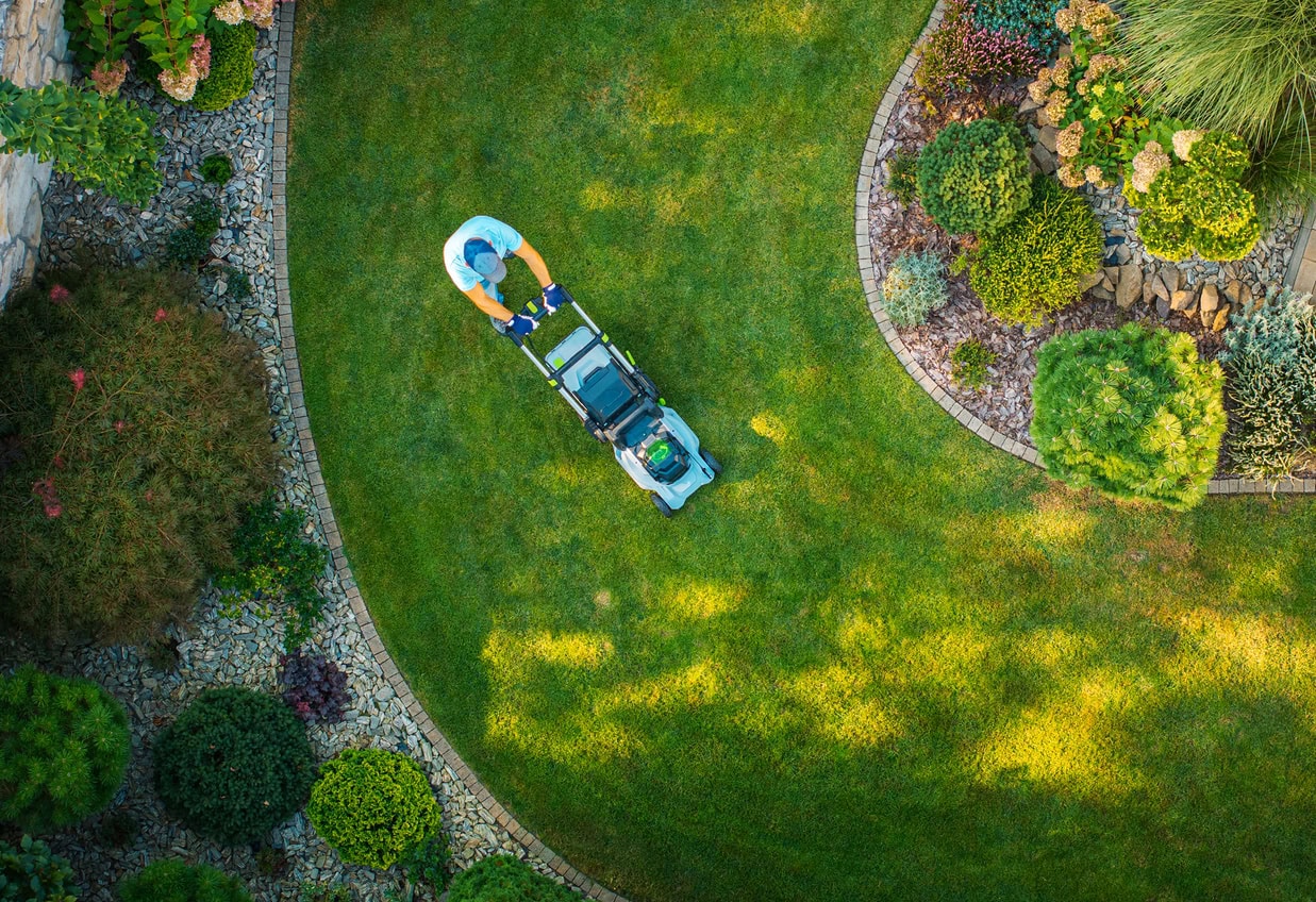 Aerial view of lawn care maintenance in a residential neighborhood representing community association management services