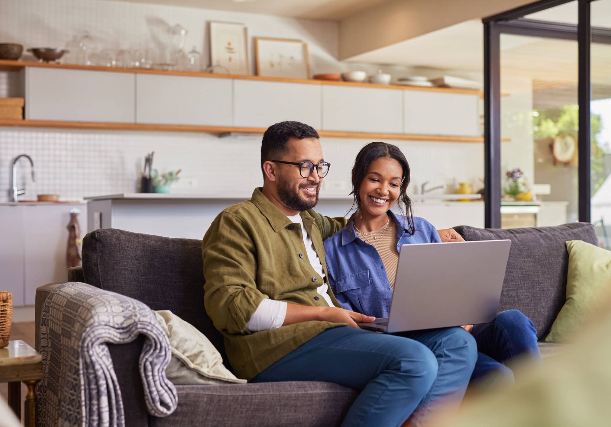 Homeowner resources with couple reviewing community documents on a laptop at home