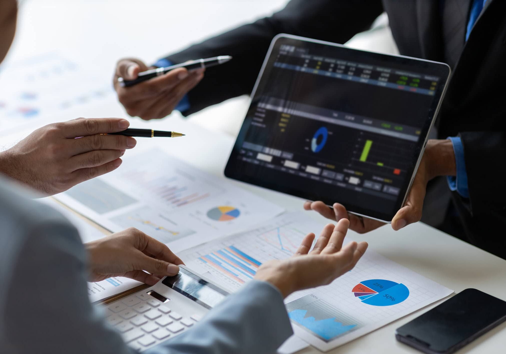 hoa management company reviewing financial reports and performance data on tablet