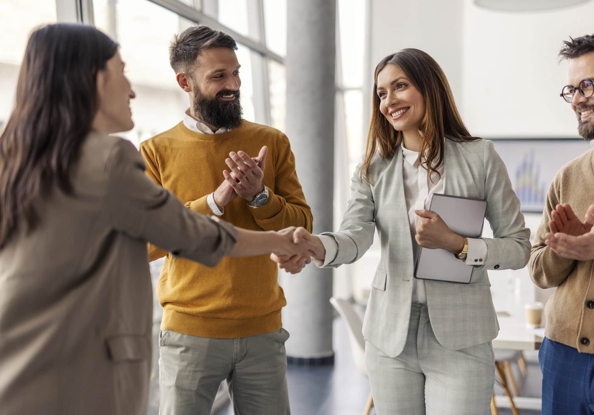 hoa management company professionals shaking hands during client meeting