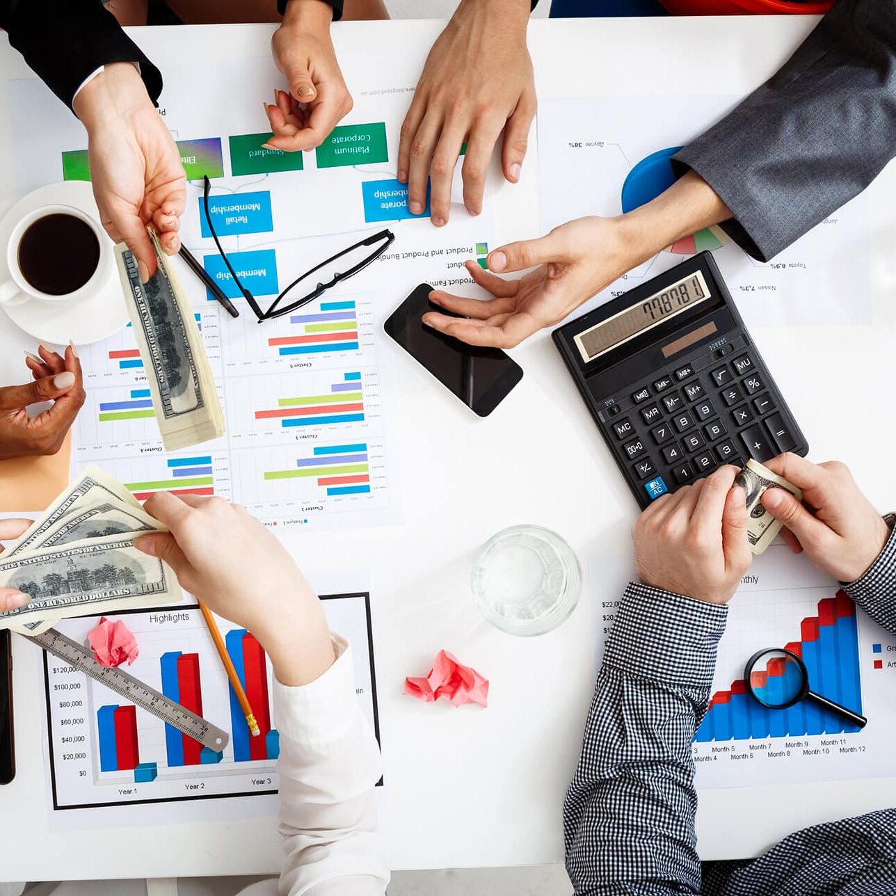 hoa management services with team reviewing financial reports, charts, and calculations